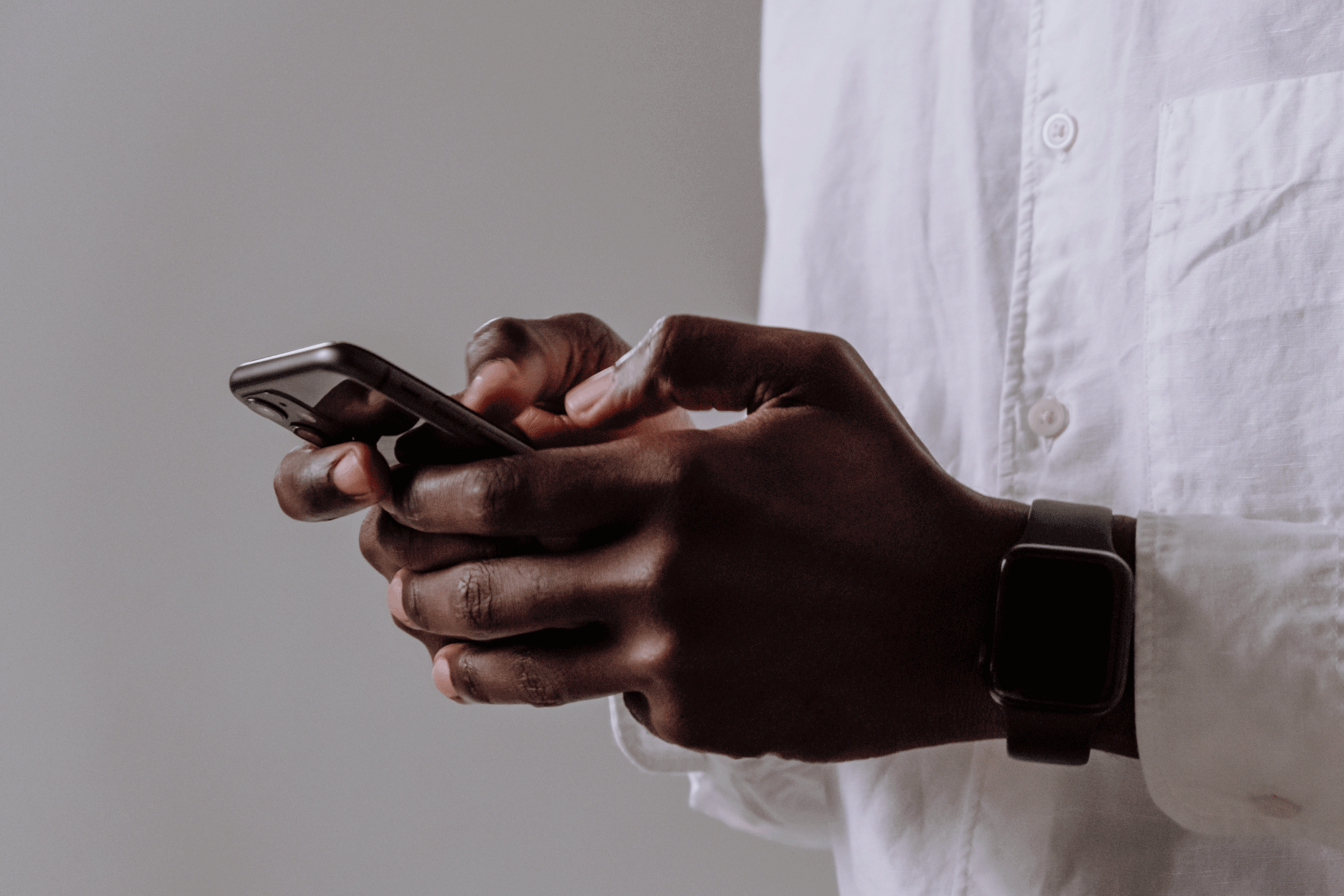 A man holding a phone, with flashing folder, brain, and checkmark symbols.