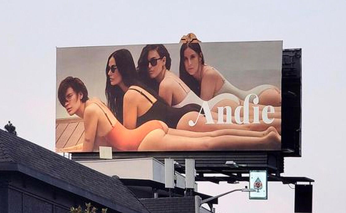 Andie's billboard featuring Demi Moore and her daughters